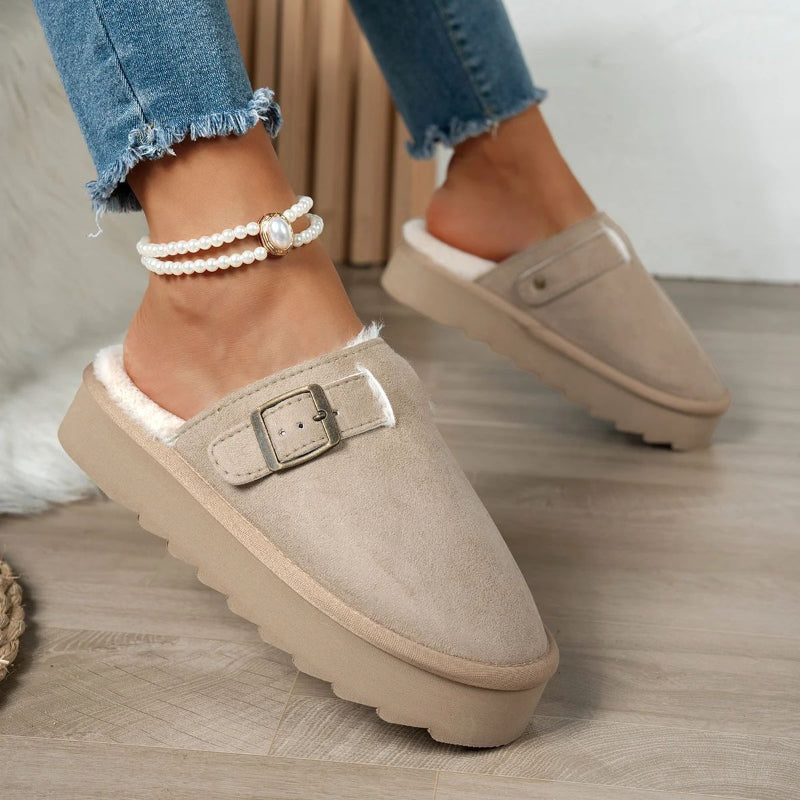 Comfortable beige suede slip-on winter slippers with buckle detail and cozy lining