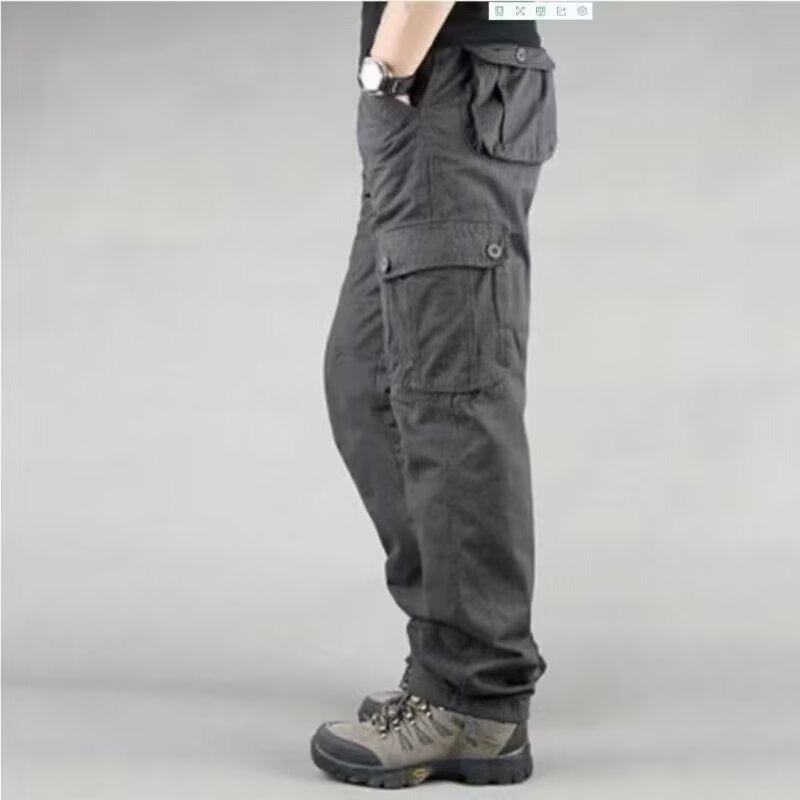 Side view of person wearing black cargo pants with multiple pockets and gray hiking boots