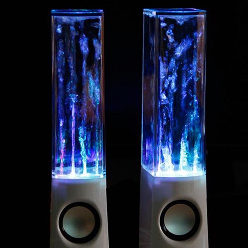 Pair of white RGB water dancing speakers with illuminated water jets in a dark setting