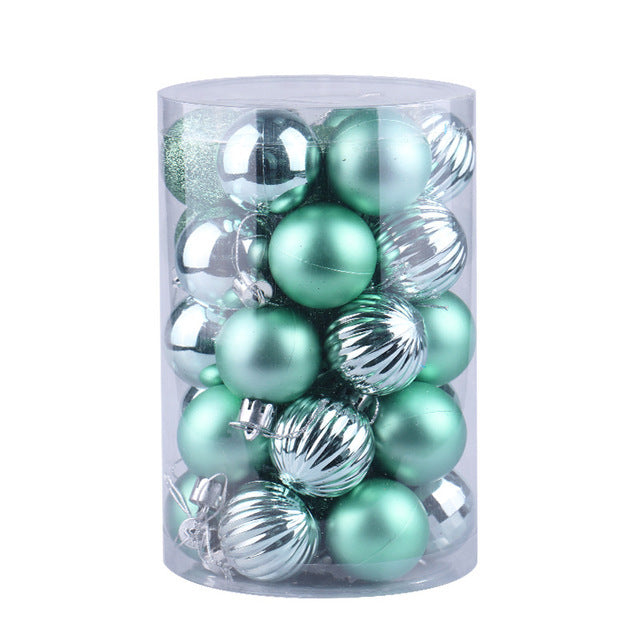 Clear cylindrical container with shiny green and silver Christmas tree ornaments