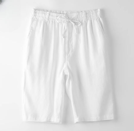 White cotton drawstring shorts with side pockets, laid flat on white background