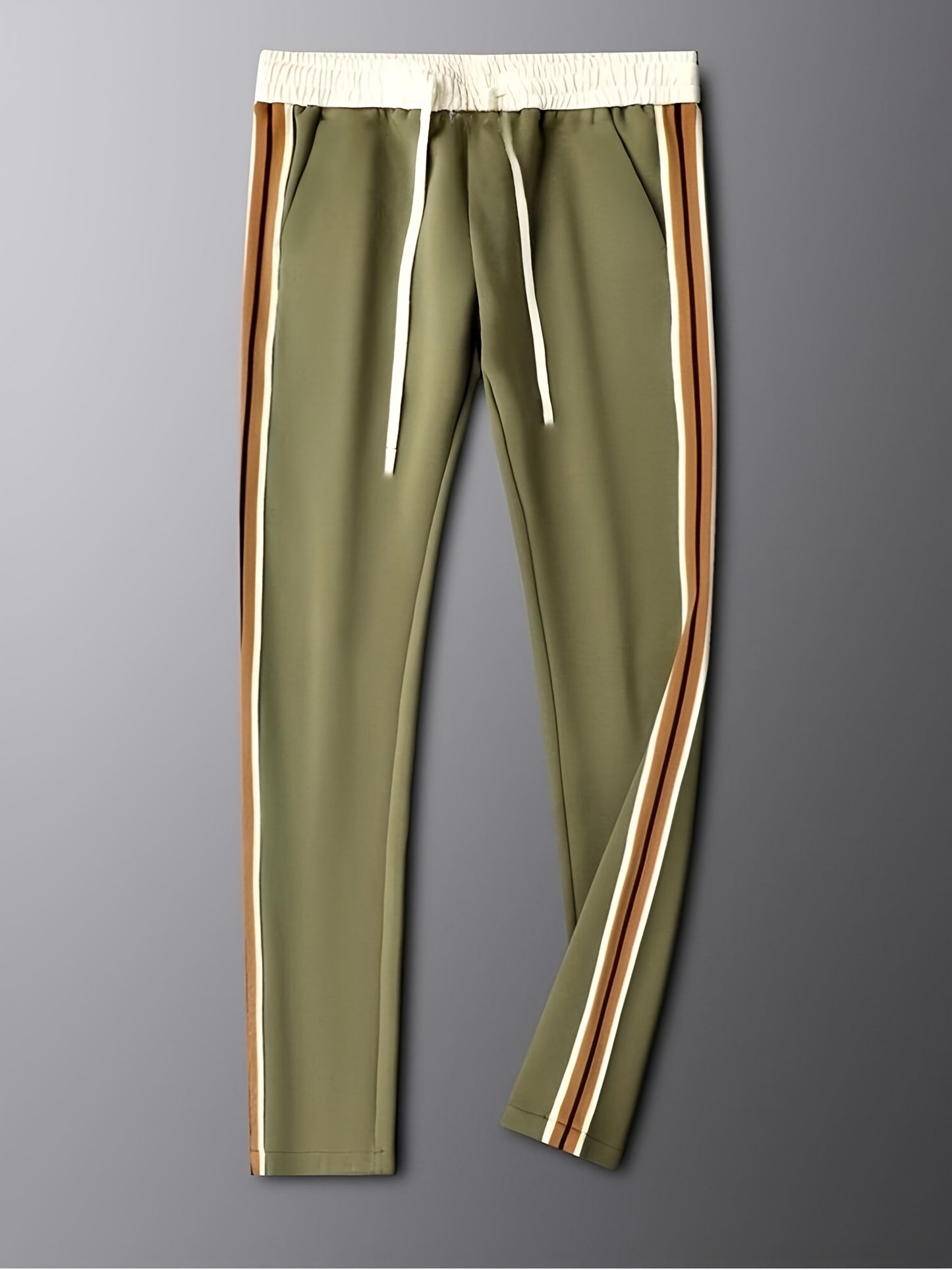 Olive green jogger pants with white elastic waistband, white drawstrings, and brown and cream side stripes