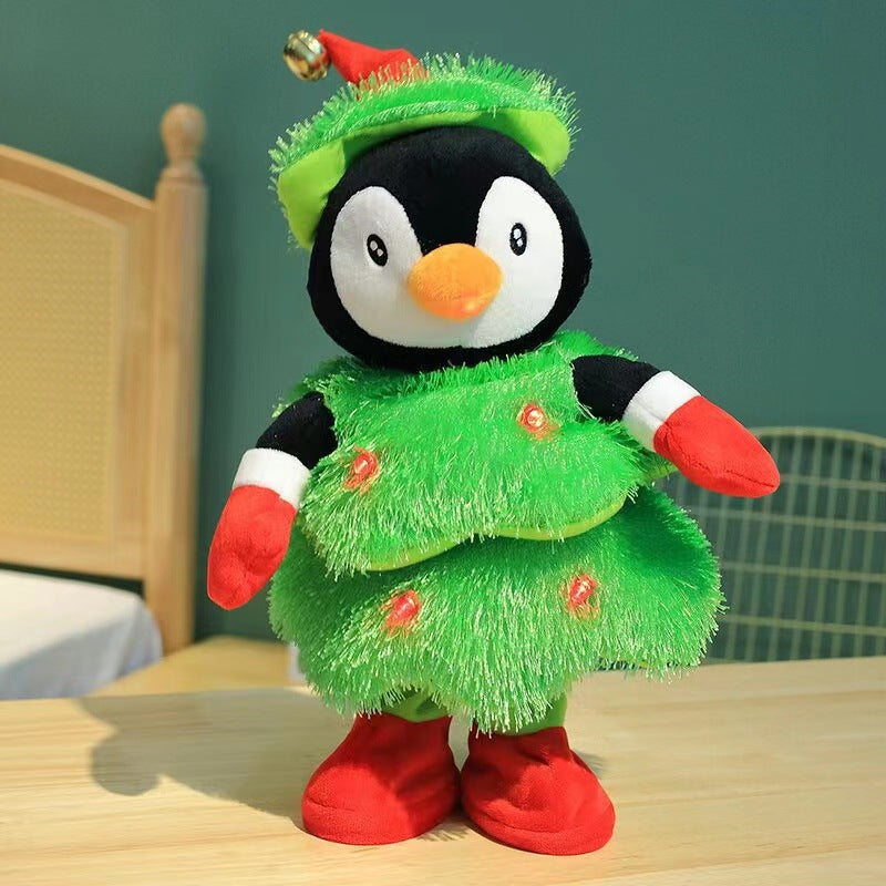 Plush penguin toy dressed in Christmas tree costume with red gloves, boots, and Santa hat on wooden table