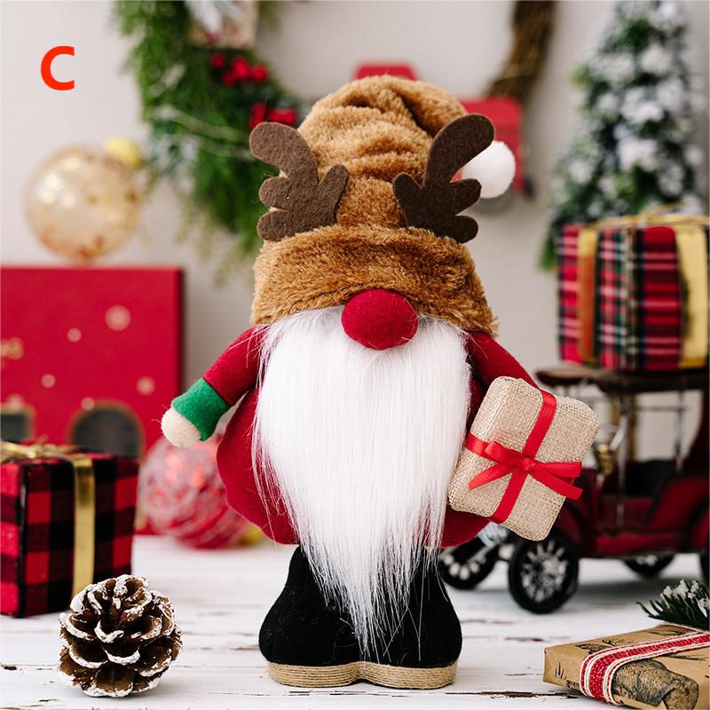 Christmas gnome figurine with reindeer hat and gift, surrounded by holiday decor and wrapped presents