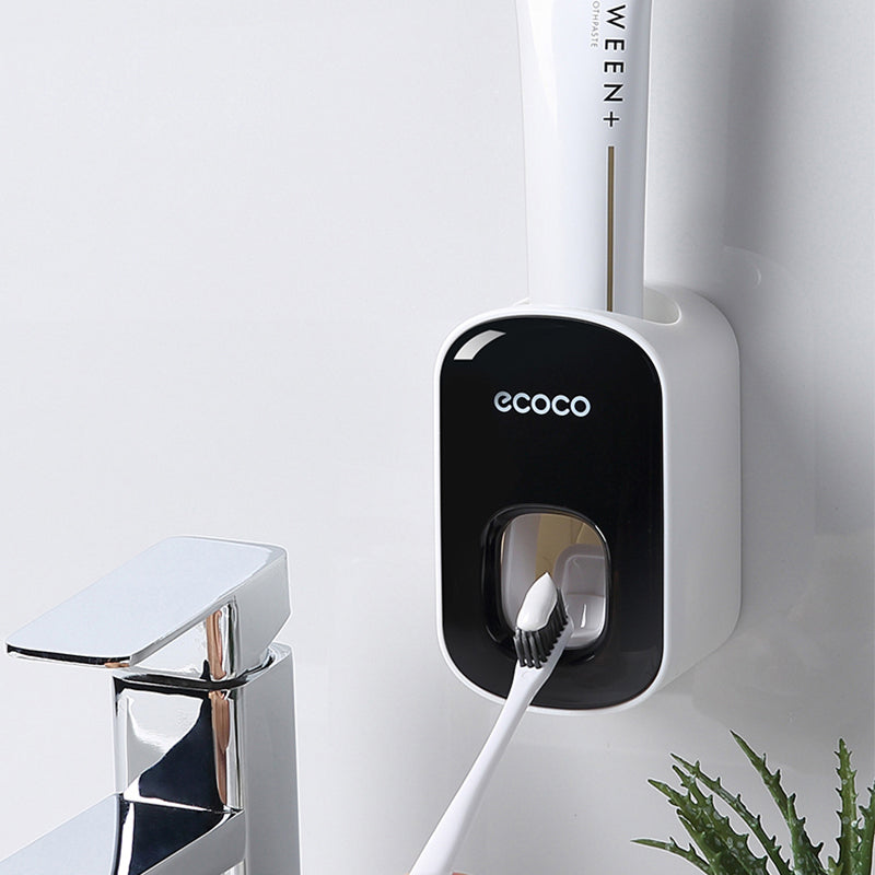 Wall-mounted Ecoco automatic toothpaste dispenser with toothbrush and tube in bathroom