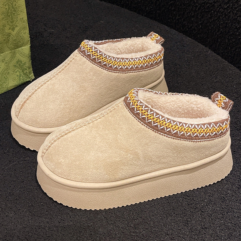 Beige indoor slippers with cozy fleece lining and decorative brown, yellow, and white stitching