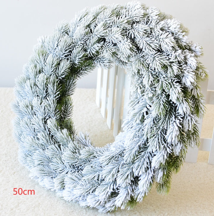 50cm snowflake pine cone Christmas wreath with frosted green pine branches on white carpet