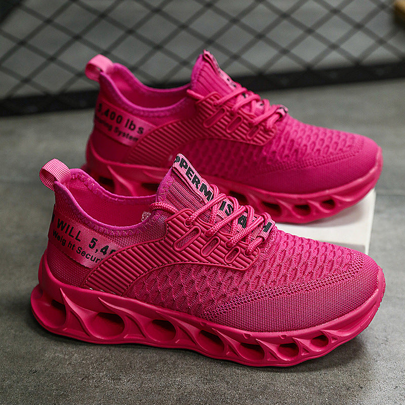 Bright pink breathable mesh running shoes with thick, ventilated soles on gray surface