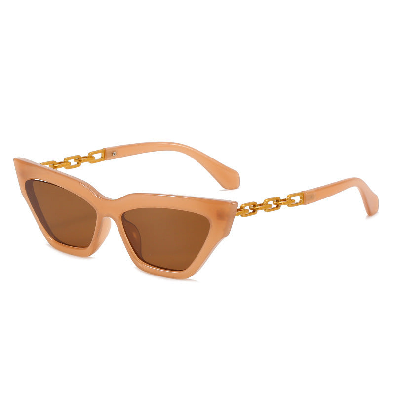 Peach cat eye sunglasses with brown lenses and gold chain link temples on white background