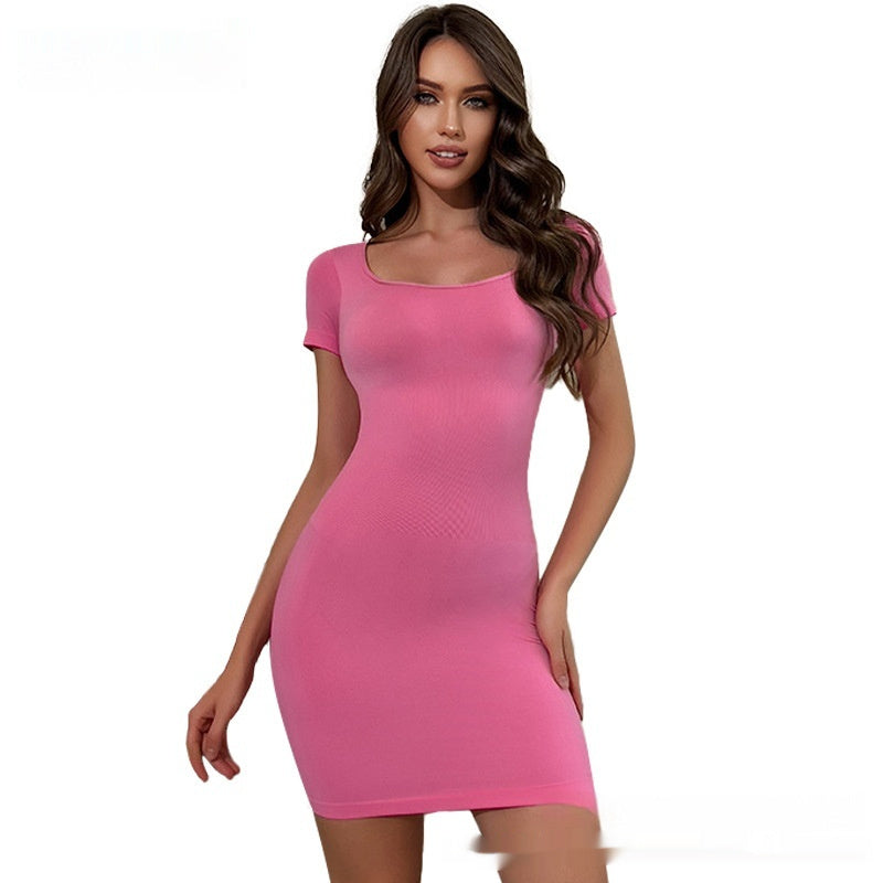 Woman wearing a pink bodycon dress with short sleeves and scoop neckline