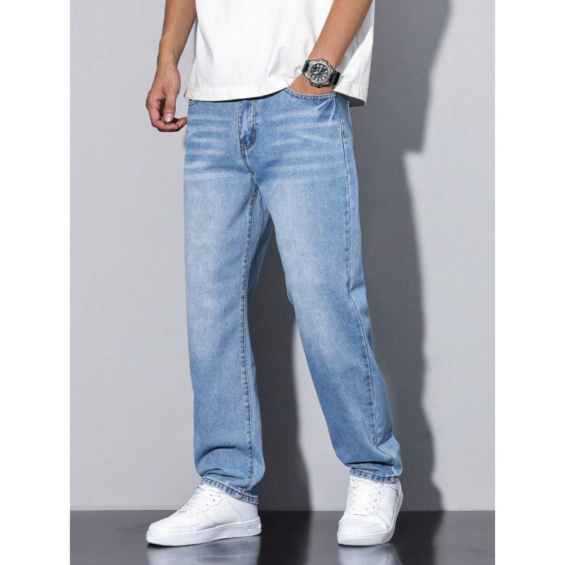 Men's light blue straight leg jeans with loose fit worn with white sneakers and white t-shirt