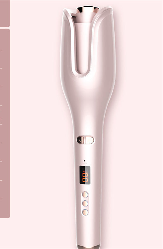 pink automatic hair curler with digital temperature display and control buttons on a pink background