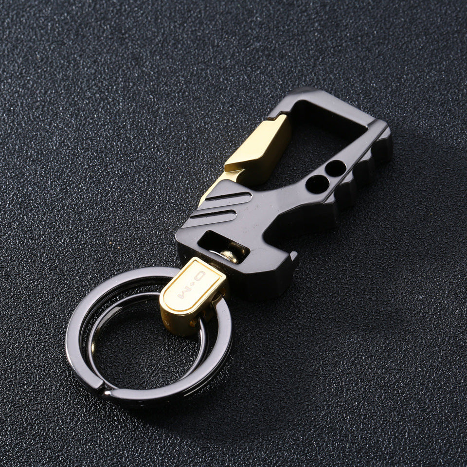 Men's leather and steel car key chain pendant in sandy gold with black textured background