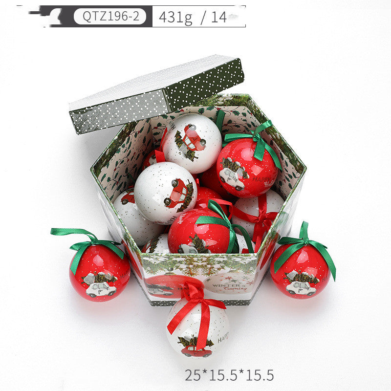 Christmas gift box filled with red and white decorative tree ornaments featuring vintage car designs with green and red ribbons