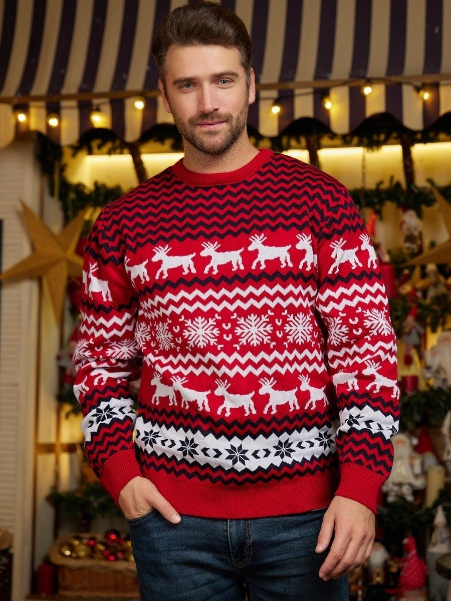 Man wearing red Christmas sweater with white reindeer and snowflake patterns in festive decorated room