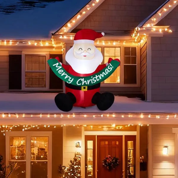 8ft lighted inflatable Santa Claus with Merry Christmas banner on snowy house roof with Christmas lights