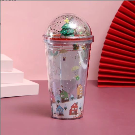 Christmas-themed water cup with 3D Christmas tree dome lid and festive village illustration