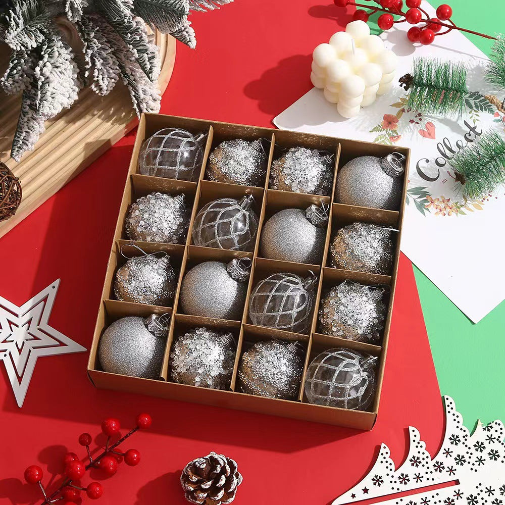 Box of silver and glitter Christmas baubles on red and green festive table with pinecones and holiday decor