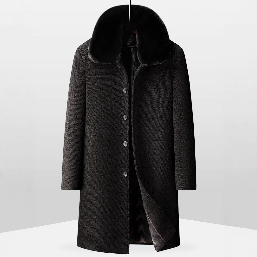 Black wool overcoat with fur collar and button closure on plain background