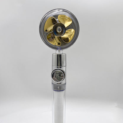 Modern handheld shower head with transparent cover and golden propeller-style blades