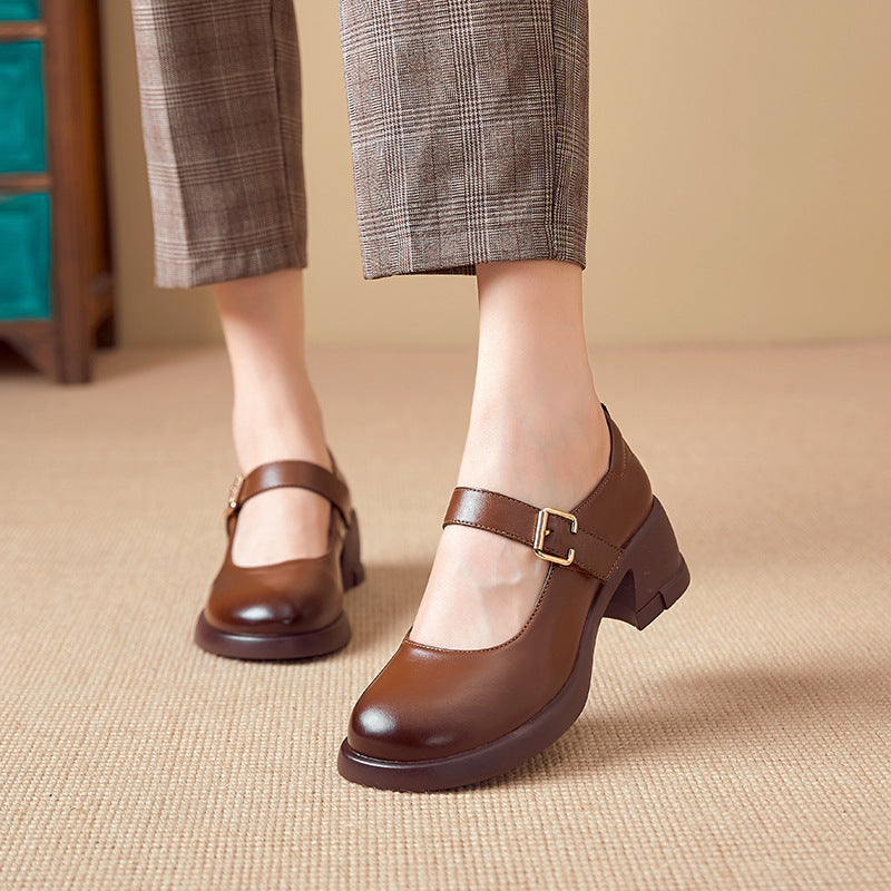Brown leather Mary Jane heels with buckle worn with checkered cropped pants on beige carpet