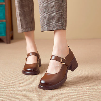 Brown leather Mary Jane heels with buckle worn with checkered cropped pants on beige carpet