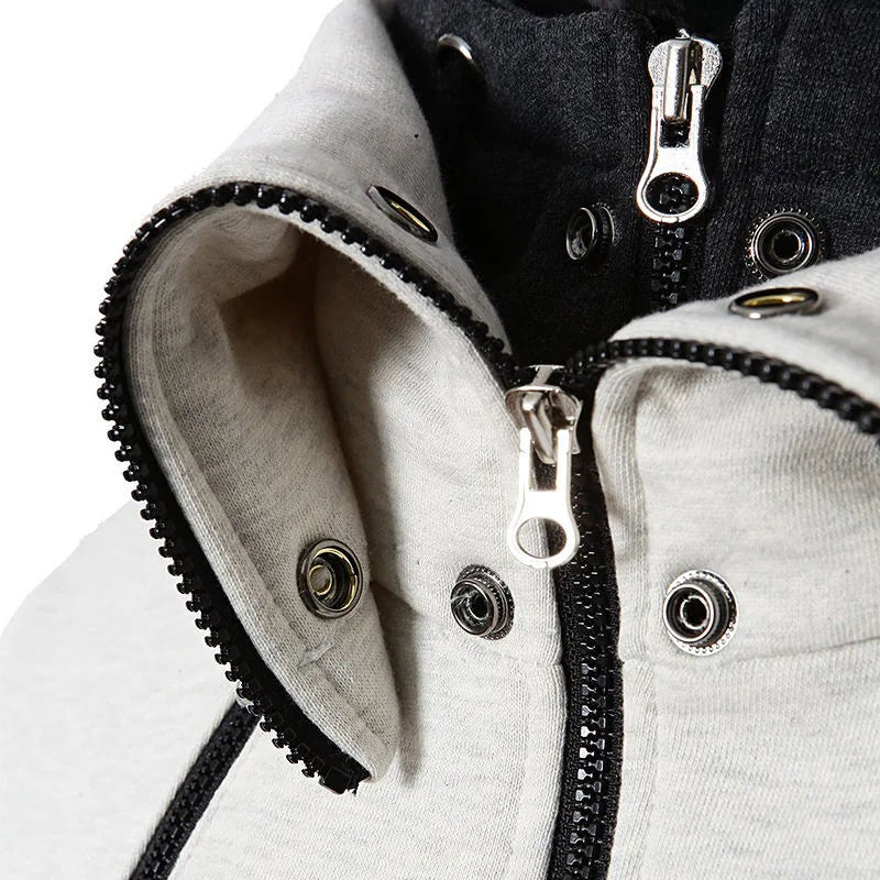 Close-up of a beige and black jacket collar with metal zippers and snap buttons