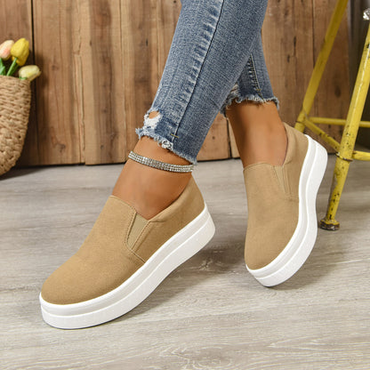 Women wearing beige slip-on platform sneakers with white soles and ripped skinny jeans