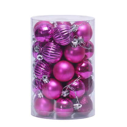 Clear cylindrical container filled with shiny pink Christmas baubles in matte, ribbed, and glitter finishes