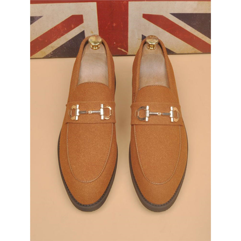 Pair of tan suede loafers with silver horsebit detail and wooden shoe trees, Union Jack background
