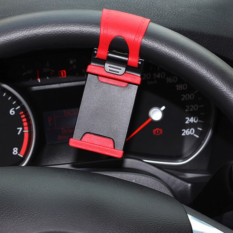 Red and black adjustable car phone holder clipped on black steering wheel with dashboard in background