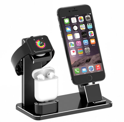 Black multi-device charging station holding Apple Watch, AirPods, and iPhone on white background