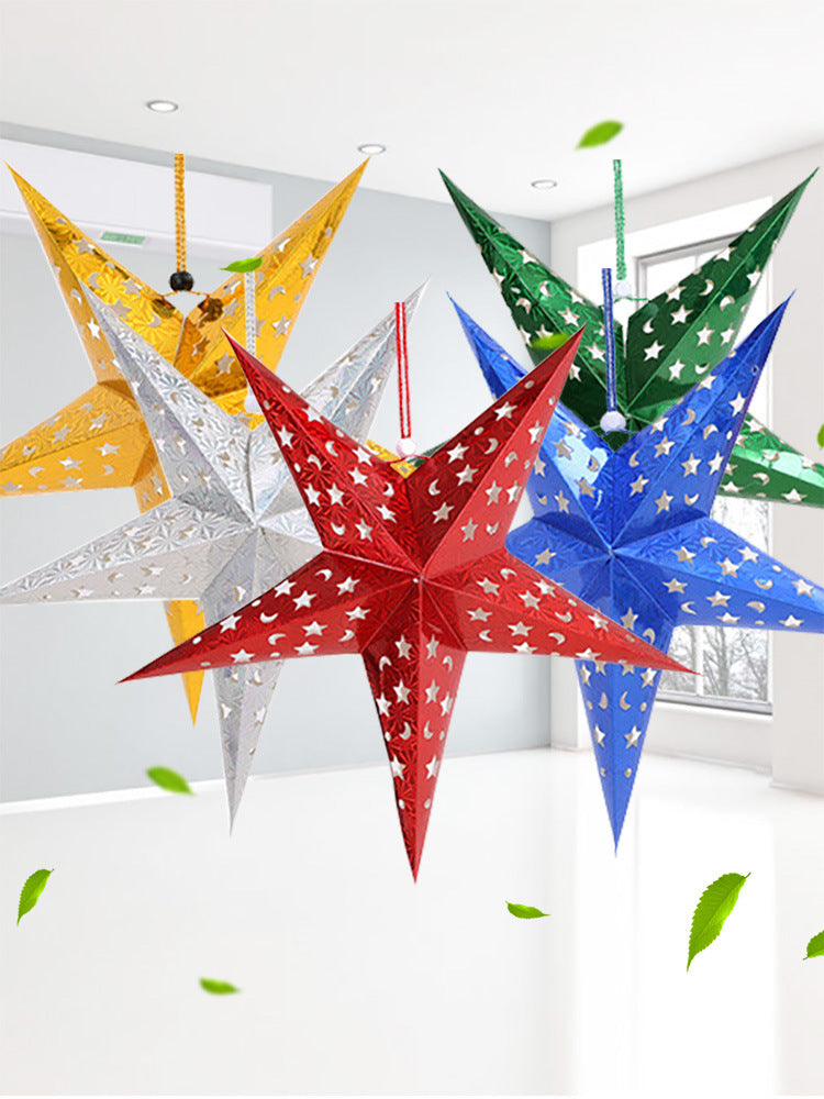 Colorful hanging star-shaped paper lanterns in red, blue, green, silver, and yellow with cutout moon and star patterns