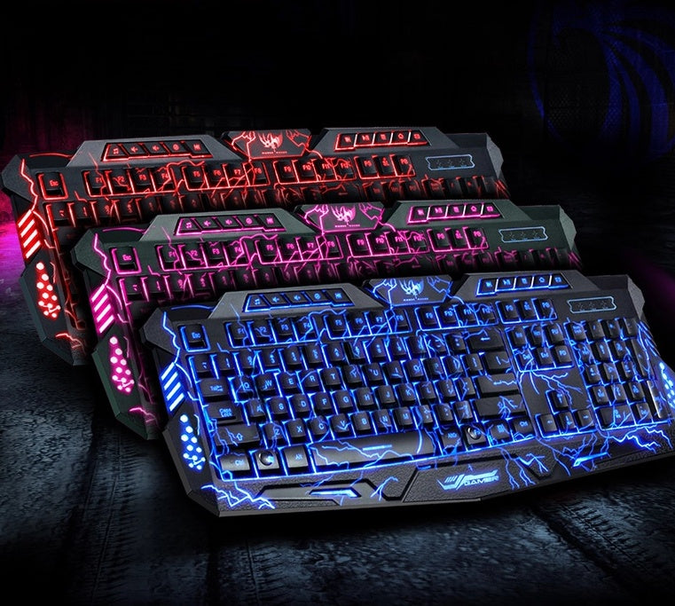 Three gaming keyboards with RGB backlight in red, pink, and blue lightning design on black surface