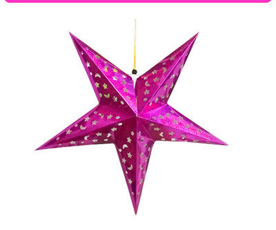 Shiny pink five-pointed star lantern decorated with moon and star cutouts hanging on a string