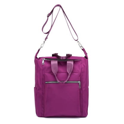 Purple nylon tote bag with dual handles, adjustable shoulder strap, and front zippered pockets