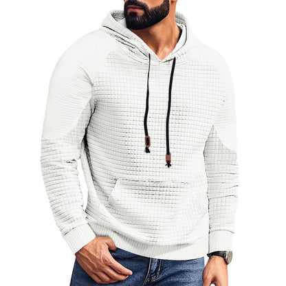 Man wearing textured white hoodie with black drawstrings and front pocket, paired with blue jeans