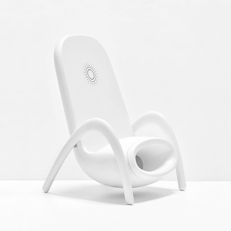 Modern white plastic chair with curved legs and perforated circular backrest design