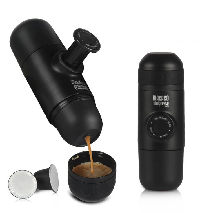 Black Wacaco Minipresso NS portable espresso maker brewing coffee with capsule pods and cup