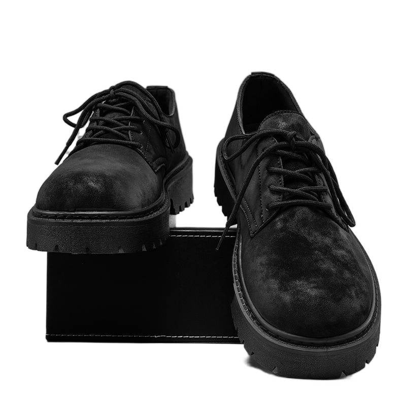 Pair of black suede lace-up chunky sole shoes on black shoebox