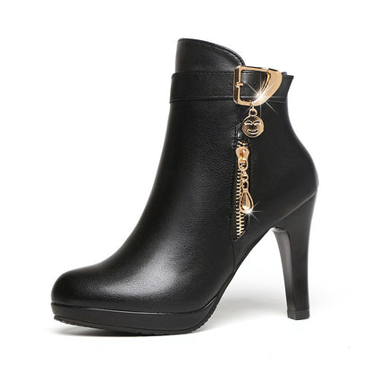Black leather high-heeled ankle boot with gold zipper and buckle charm