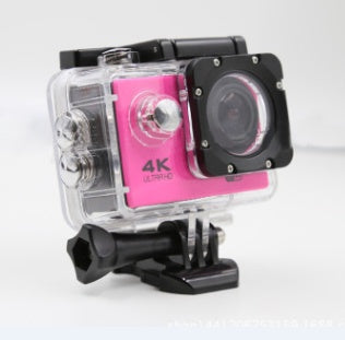 Pink 4K Ultra HD action camera in clear waterproof case with black mount on white background