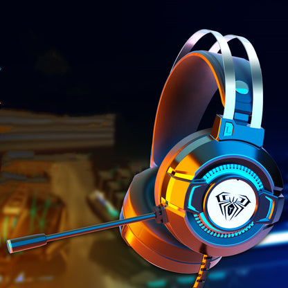 Modern gaming headset with microphone and spider logo, illuminated in orange and blue lighting