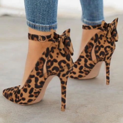 Leopard print high heel shoes with ankle strap and bow detail worn with blue jeans