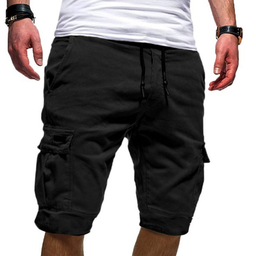 Man wearing black cargo shorts with drawstring and pockets, paired with white t-shirt
