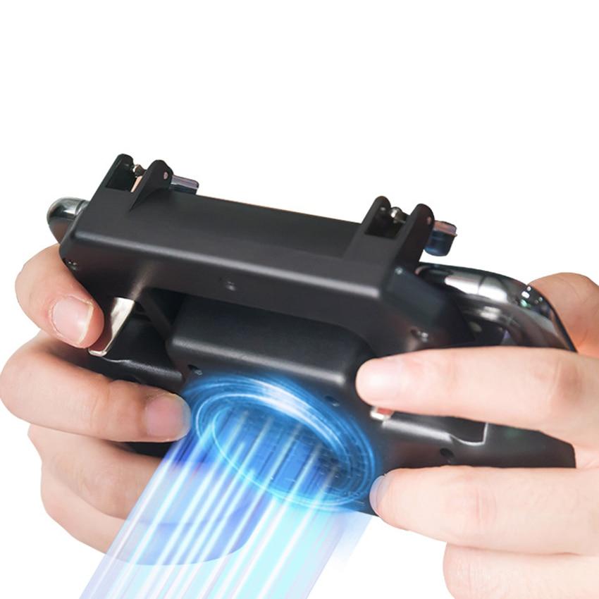 Hands holding black mobile game controller with built-in cooling fan and blue light effect