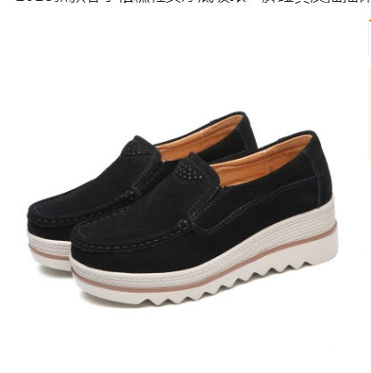 Black suede platform slip-on women's shoes with white ridged soles and tan interior lining