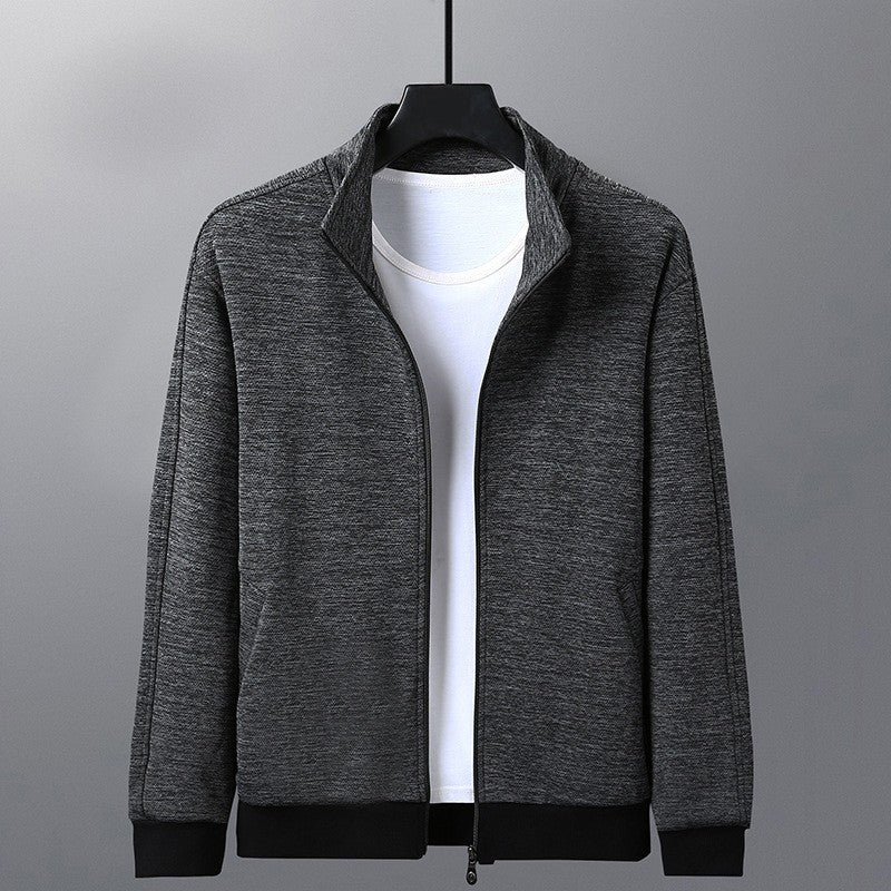 Dark gray zip-up jacket over white t-shirt on black hanger against gray background
