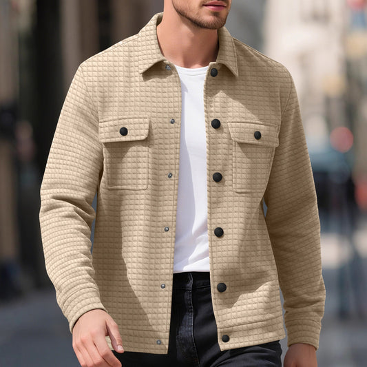 Casual beige quilted jacket with black buttons on male model wearing white t-shirt and black pants