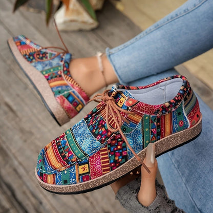 Colorful bohemian patterned casual shoes with cork soles, worn with light blue jeans